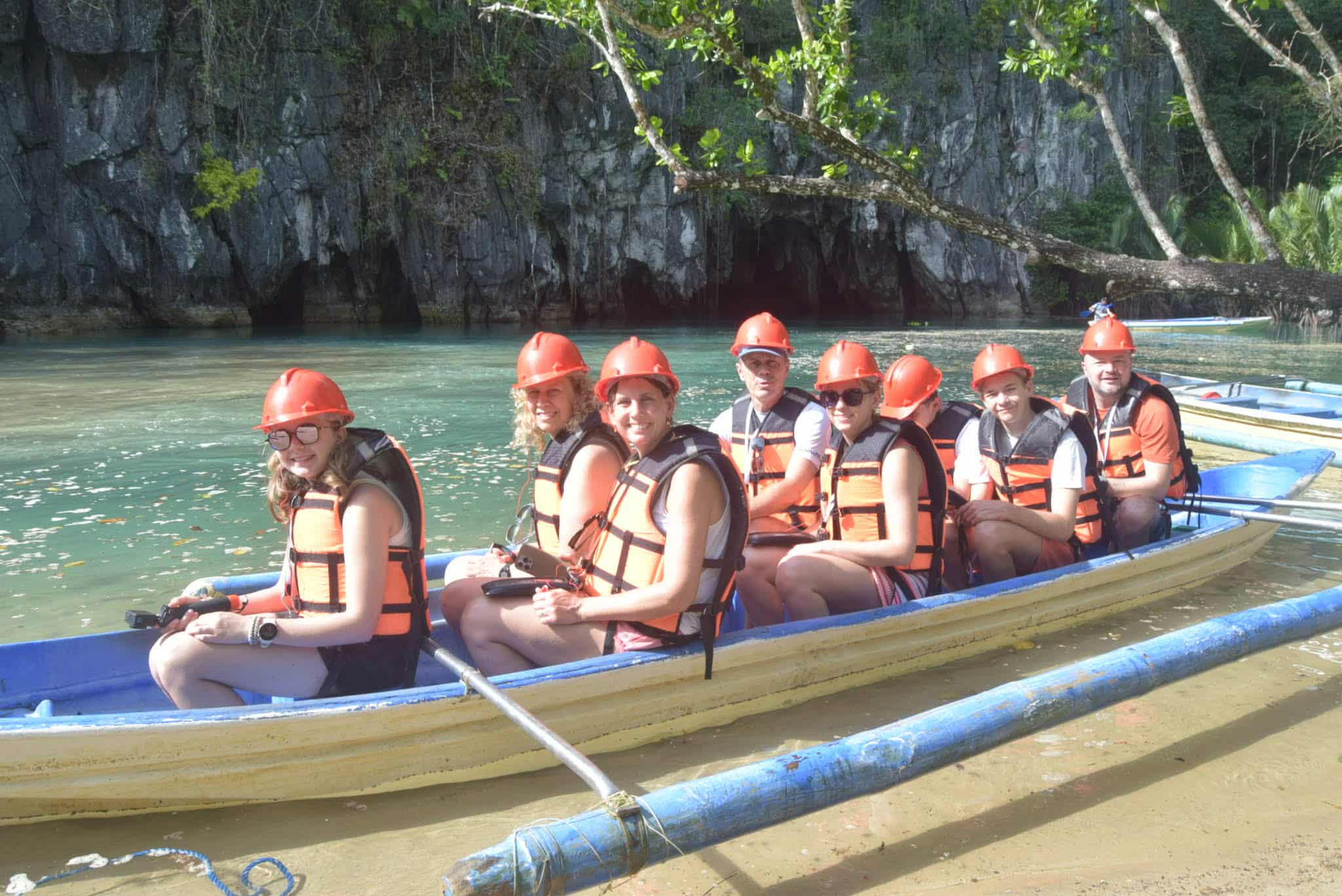 Guests in helmets and life jackets aboard the Underground River boat in Puerto Princesa