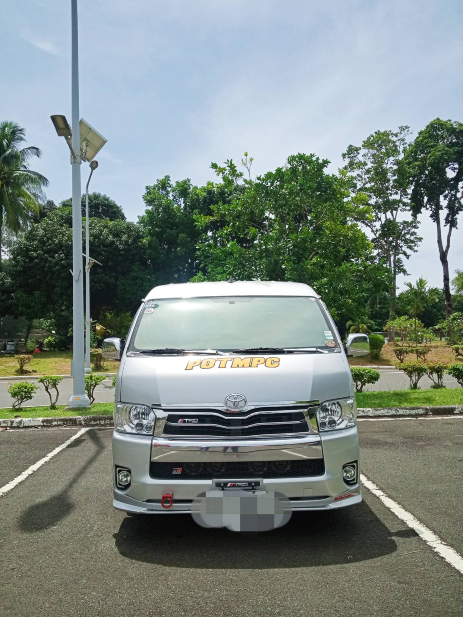 Front view of a premium transfer van parked and ready for guest pickup