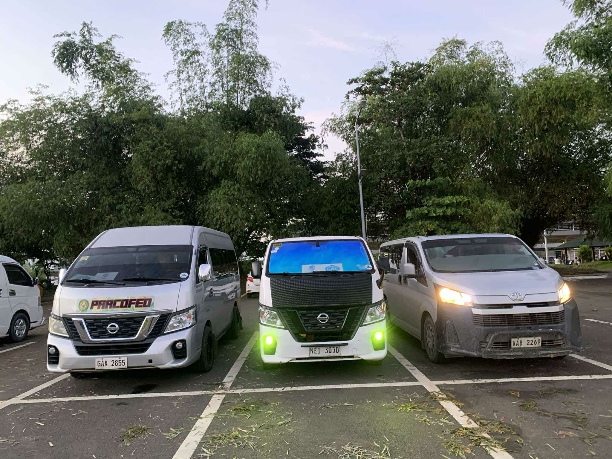 Three private vans lined up and ready for group transfers in Palawan